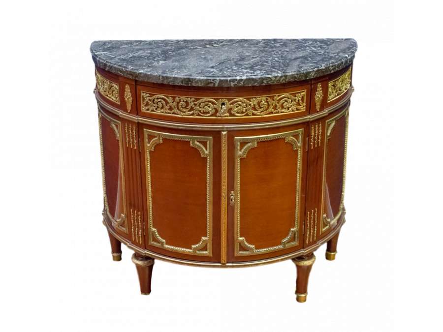 A Louis XVI style demi-lune commode. 19th century.