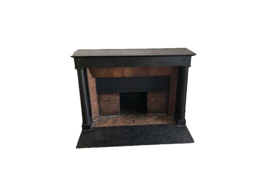 Elegant antique empire style fireplace with black marble columns dating from the end of the 19th...
