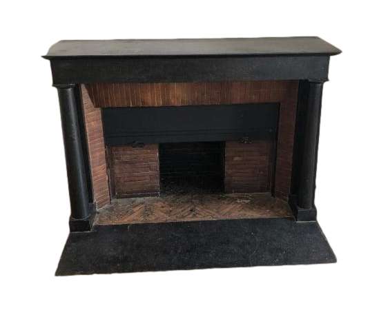 Elegant antique empire style fireplace with black marble columns dating from the end of the 19th...