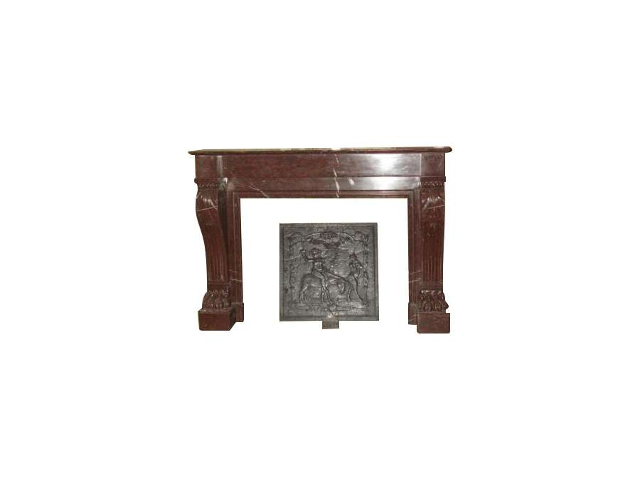 Old empire style fireplace known as lion's feet in red griotte marble dating from 19th century.