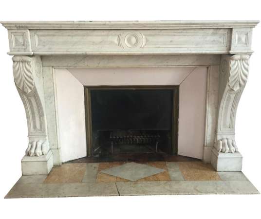 Antique empire style fireplace in white carrara marble dating from the end of the 19th century.