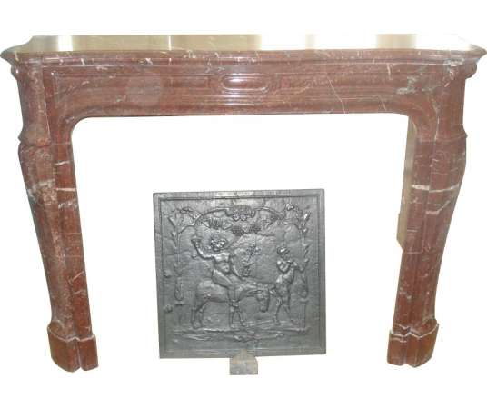 Antique pompadour style fireplace in cherry red marble from the end of the 19th century.