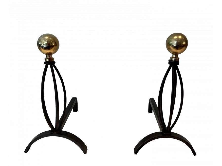 Wrought iron andirons. +Contemporary art from 1970