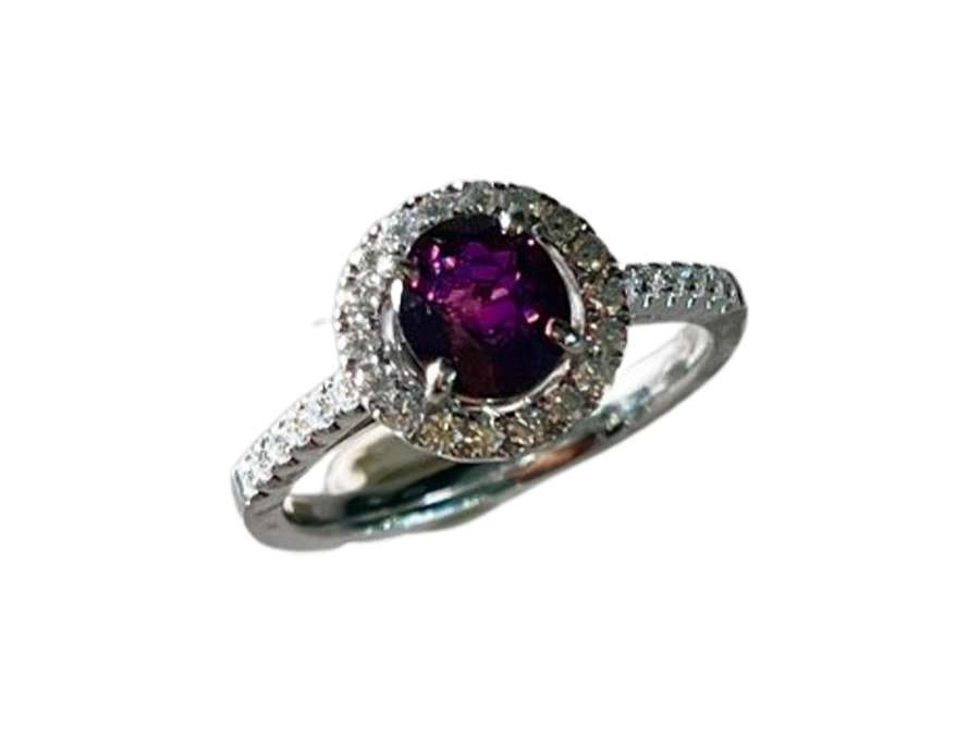 Gold ring set with a rare certified red purple sapphire