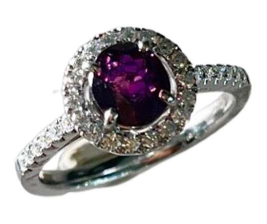 Gold ring set with a rare certified red purple sapphire