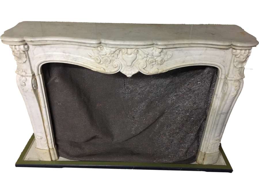 Elegant antique Louis XV style fireplace made of white Carrara marble dating from the end of the...