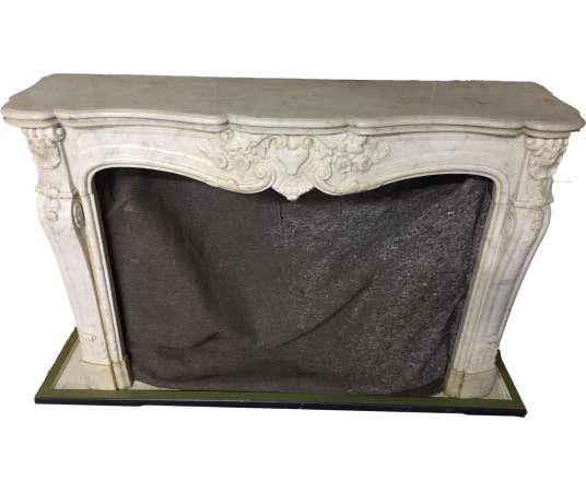 Elegant antique Louis XV style fireplace made of white Carrara marble dating from the end of the...